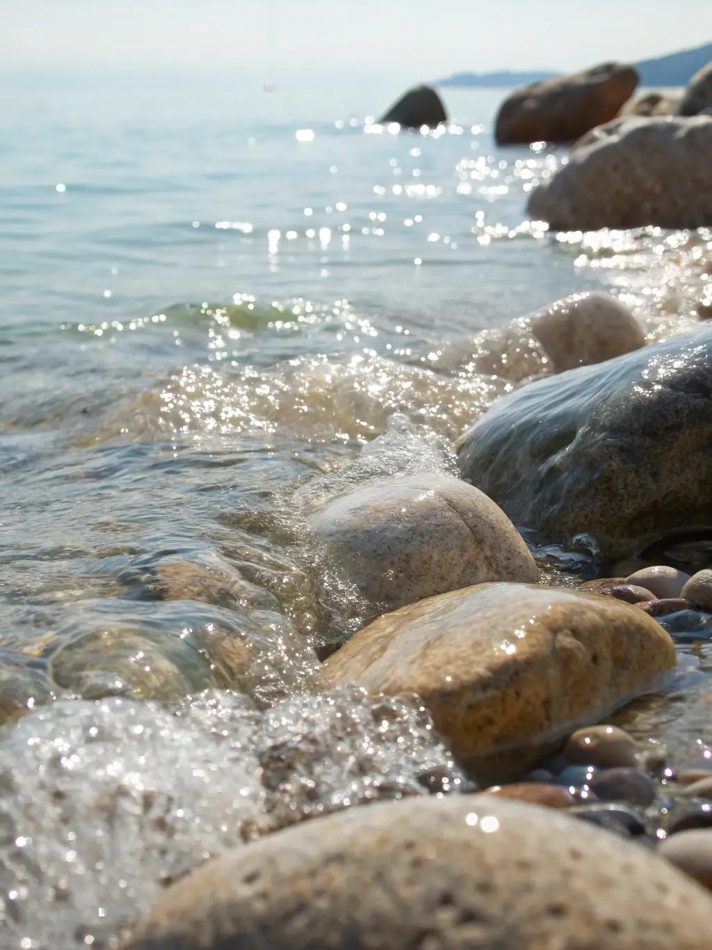 A lagoon-style aquascape with a shallow sand bed, scattered rock islands, and soft corals swaying gently in the current, creating a peaceful and natural scene in a saltwater aquarium.